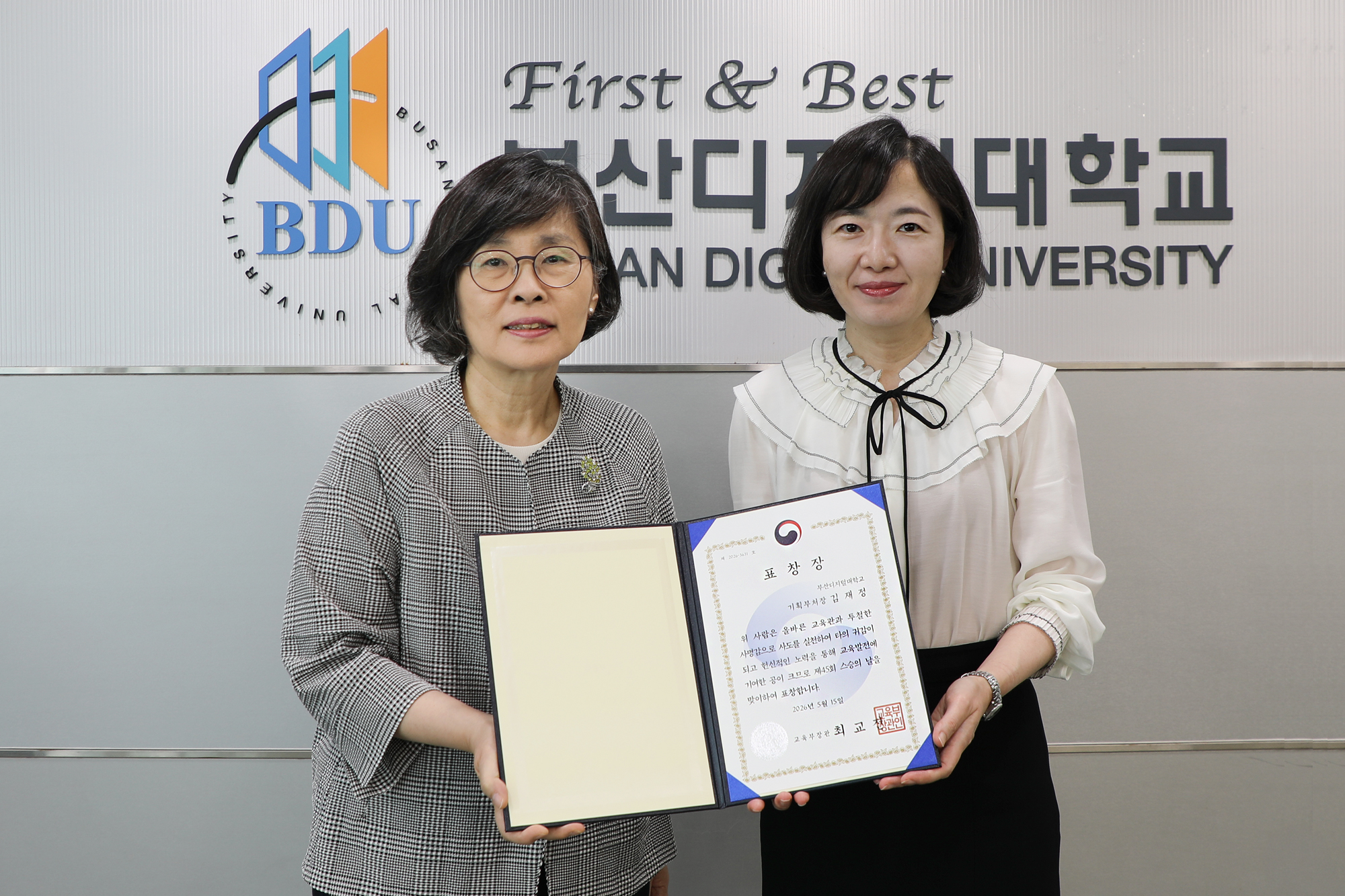 김정선 총장, 김재정 교수 제45회 스승의 날 교육부장관 표창 전수식에서 표창을 들고 있는 모습